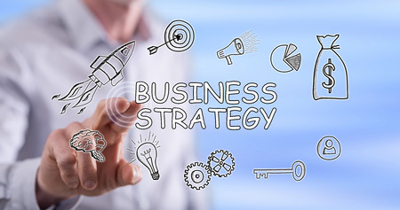 Man touching a business strategy concept on a touch screen with his fingerの写真素材