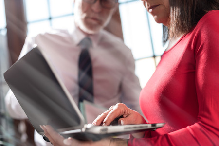 Senior manager working with executive assistant in officeの写真素材