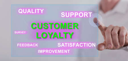 Man touching a customer loyalty concept on a touch screen with his fingerの写真素材