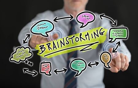 Man touching a brainstorming concept on a touch screen with his fingersの写真素材