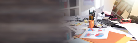 Messy and cluttered office deskの写真素材