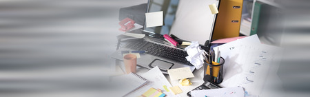 Messy and cluttered office deskの写真素材