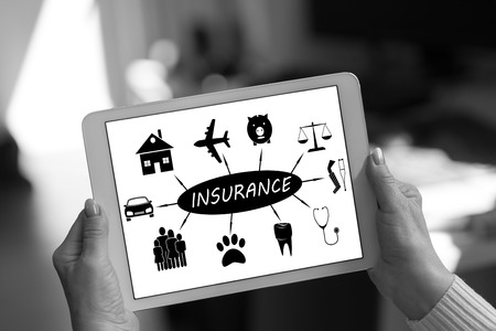 Insurance concept shown on a tablet held by a womanの写真素材