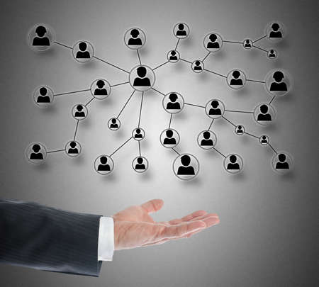 Social network concept levitating above a hand on grey backgroundの写真素材