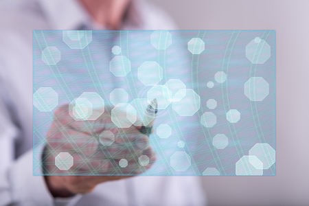 Man touching an abstract network concept on a touch screen with a penの写真素材