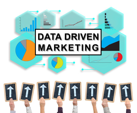 Hands holding writing slates with arrows pointing on data driven marketing conceptの写真素材