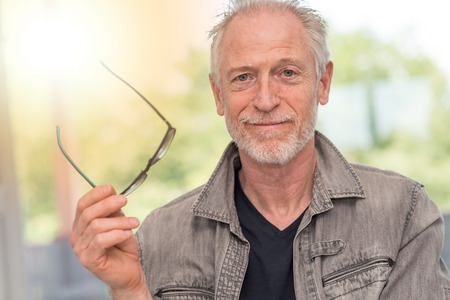 Portrait of satisfied mature man, light effectの写真素材