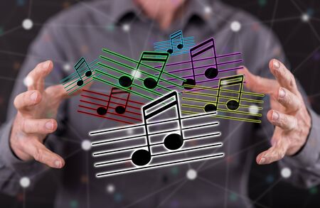 Music concept between hands of a man in backgroundの写真素材