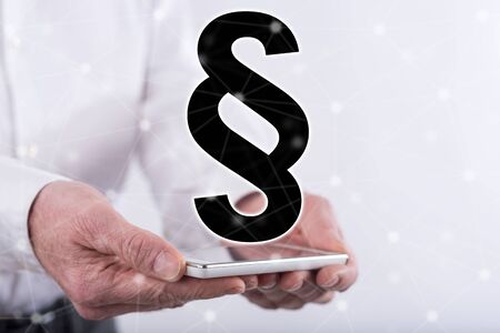 Law concept above a smartphone held by hands