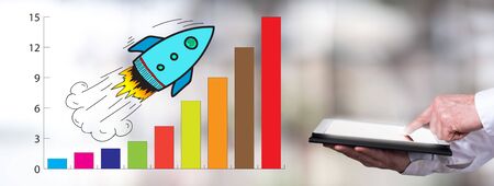 Man using a tablet with business success conceptの写真素材