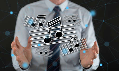 Music concept between hands of a man in backgroundの写真素材