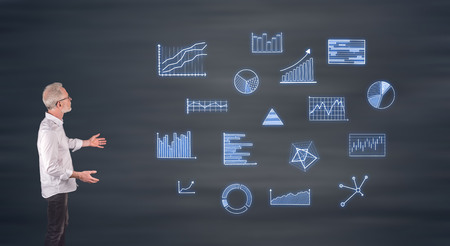 Businessman showing business charts on a wall screenの写真素材