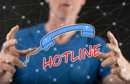 Hotline concept between hands of a man in backgroundの写真素材