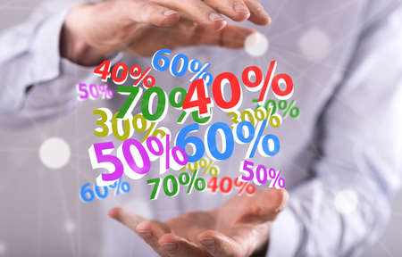 Percent discount concept between hands of a man in backgroundの写真素材