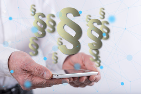 Law concept above a smartphone held by hands