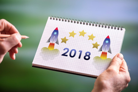 Hand drawing new year 2018 concept on a notepad