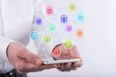 Social network concept above a smartphone held by hands