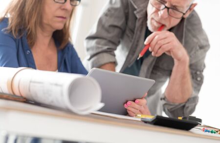 Architects working on plans at office
