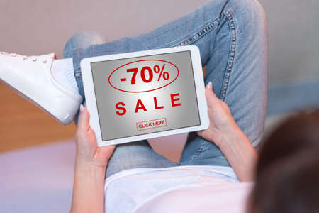 Woman looking at sale concept on a tabletの写真素材