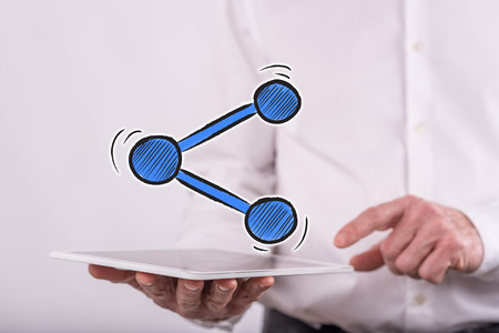 Share concept above a tablet held by a man in background