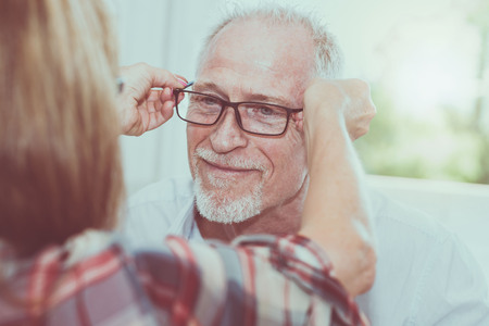 Senior man testing new eyeglasses in optician storeの写真素材