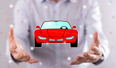 Car transport concept above the hands of a man in backgroundの写真素材