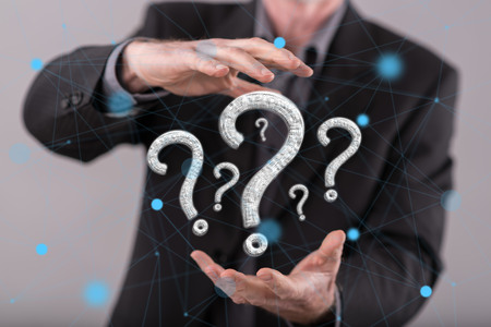 Question concept between hands of a man in backgroundの写真素材