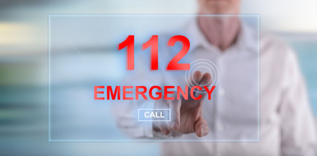 Man touching an emergency concept on a touch screen with his finger