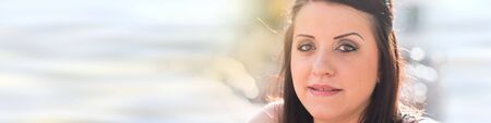 Portrait of pretty young woman looking at the camera, outsideの写真素材