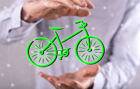 Eco travel concept between hands of a man in backgroundの写真素材