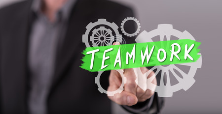 Man touching a teamwork concept on a touch screen with his fingerの写真素材