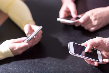 View of people hands using mobile phonesの写真素材