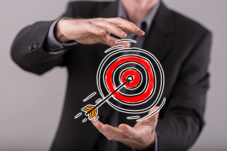 Business target concept between hands of a man in background