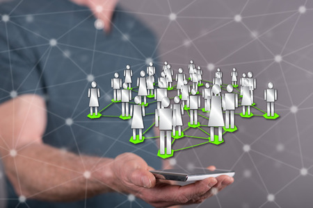 Social network concept above a smartphone held by a man in background