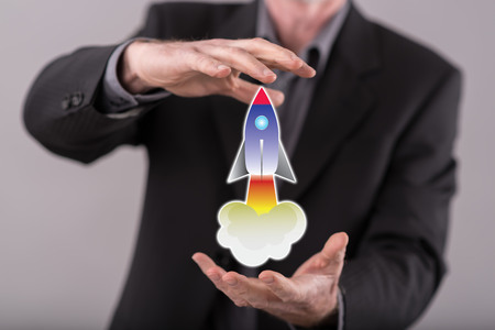 Startup concept between hands of a man in backgroundの写真素材