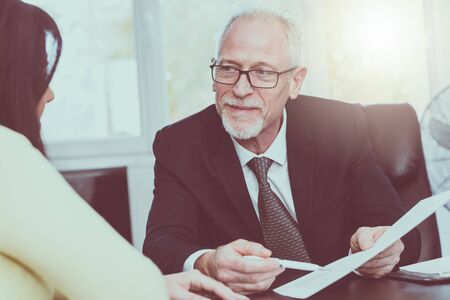 Consultant advising young woman at office, light effect