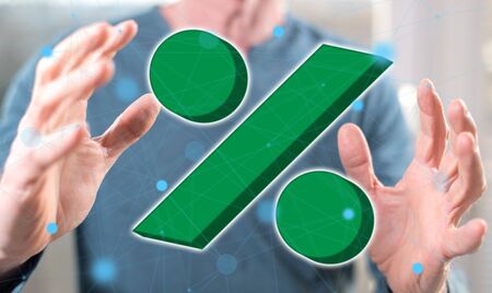 Percent concept between hands of a man in backgroundの写真素材