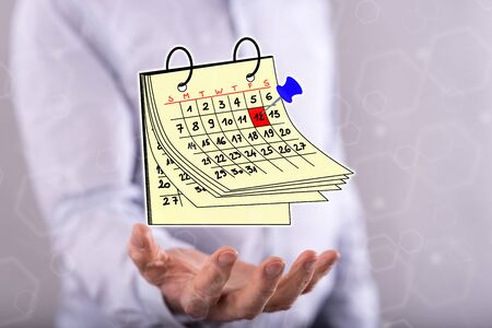 Calendar concept above the hand of a man in backgroundの写真素材
