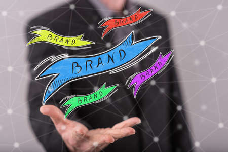 Brand concept above the hand of a man in backgroundの写真素材