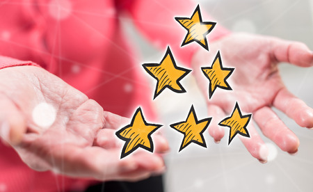 Quality concept above the hands of a woman in backgroundの写真素材