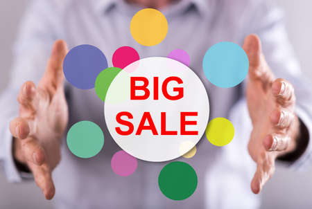 Big sale concept between hands of a man in backgroundの写真素材