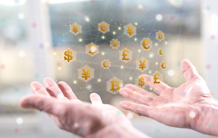 Currency exchange concept above the hands of a manの写真素材