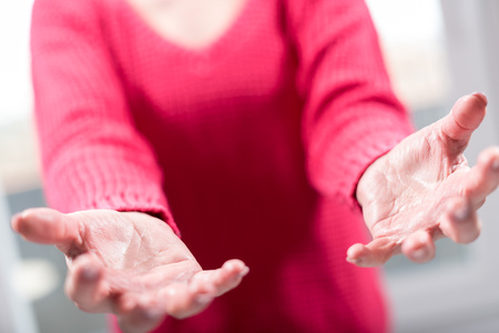 Hands of woman in gesture of support, selective focusの写真素材