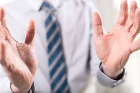 Hands of man in gesture of protection, selective focusの写真素材