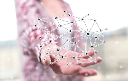 Virtual network concept above the hand of a woman in backgroundの写真素材