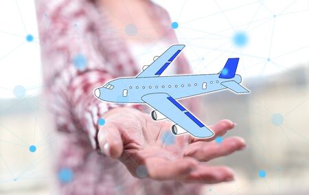 Air transport concept above the hand of a woman in backgroundの写真素材