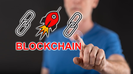 Man touching a blockchain success concept on a touch screen with his finger