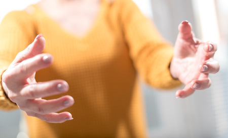 Hands of woman in gesture of support, selective focusの写真素材