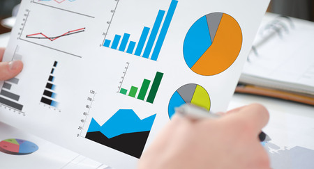 Hands holding a paper showing a graphical analysis concept