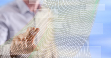 Man touching a virtual technology concept on a touch screen with his fingerの写真素材